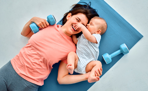 mother and baby on exercise mat with weights enjoying playful moment warmth of family fitness four